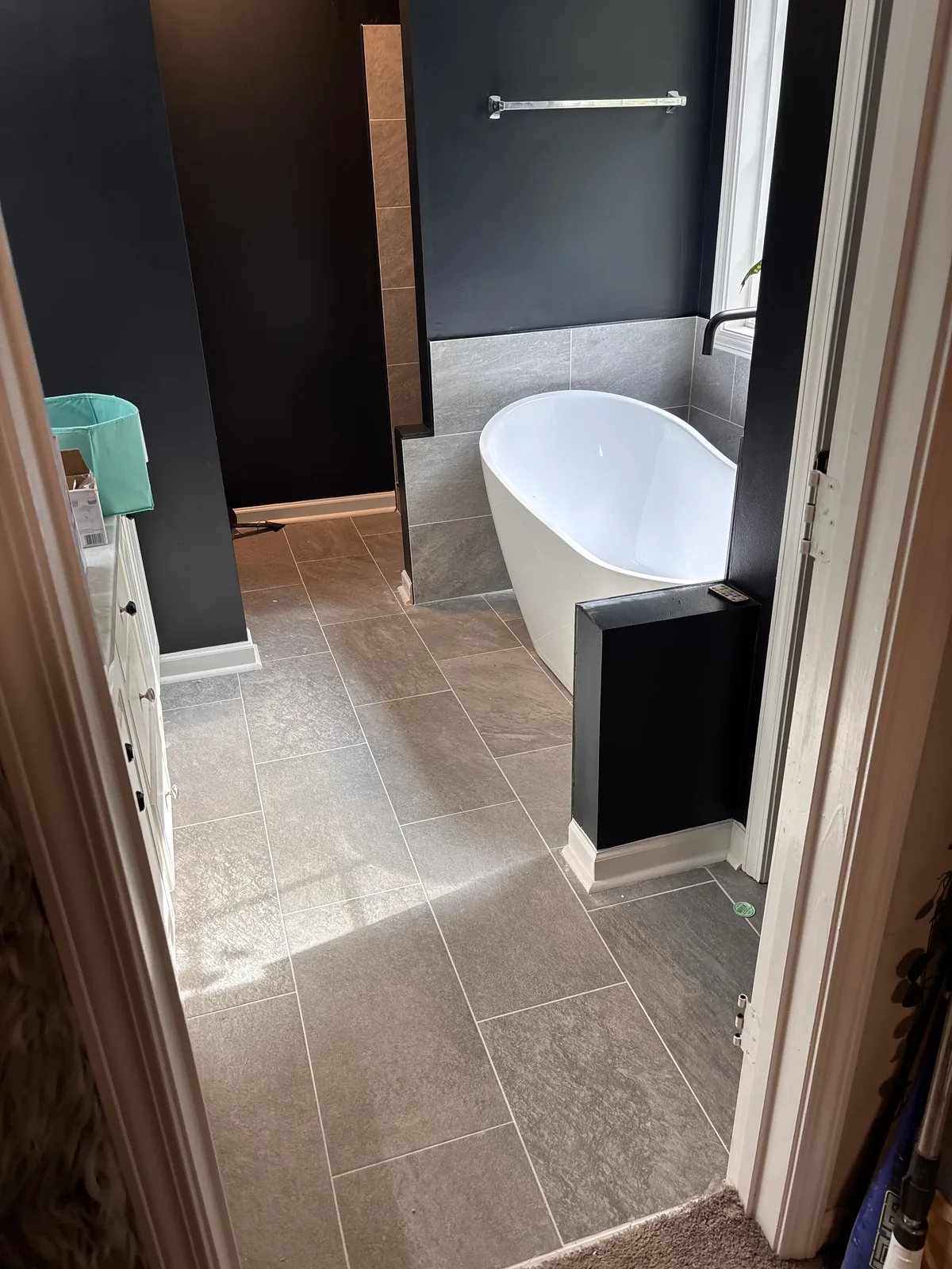 The tub and tile floor seen from the hallway
