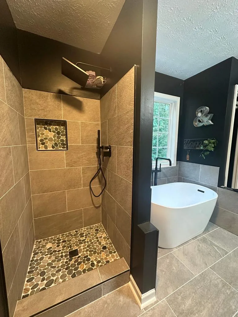 The finished bathroom, shower on the left and the tub beyond the half wall