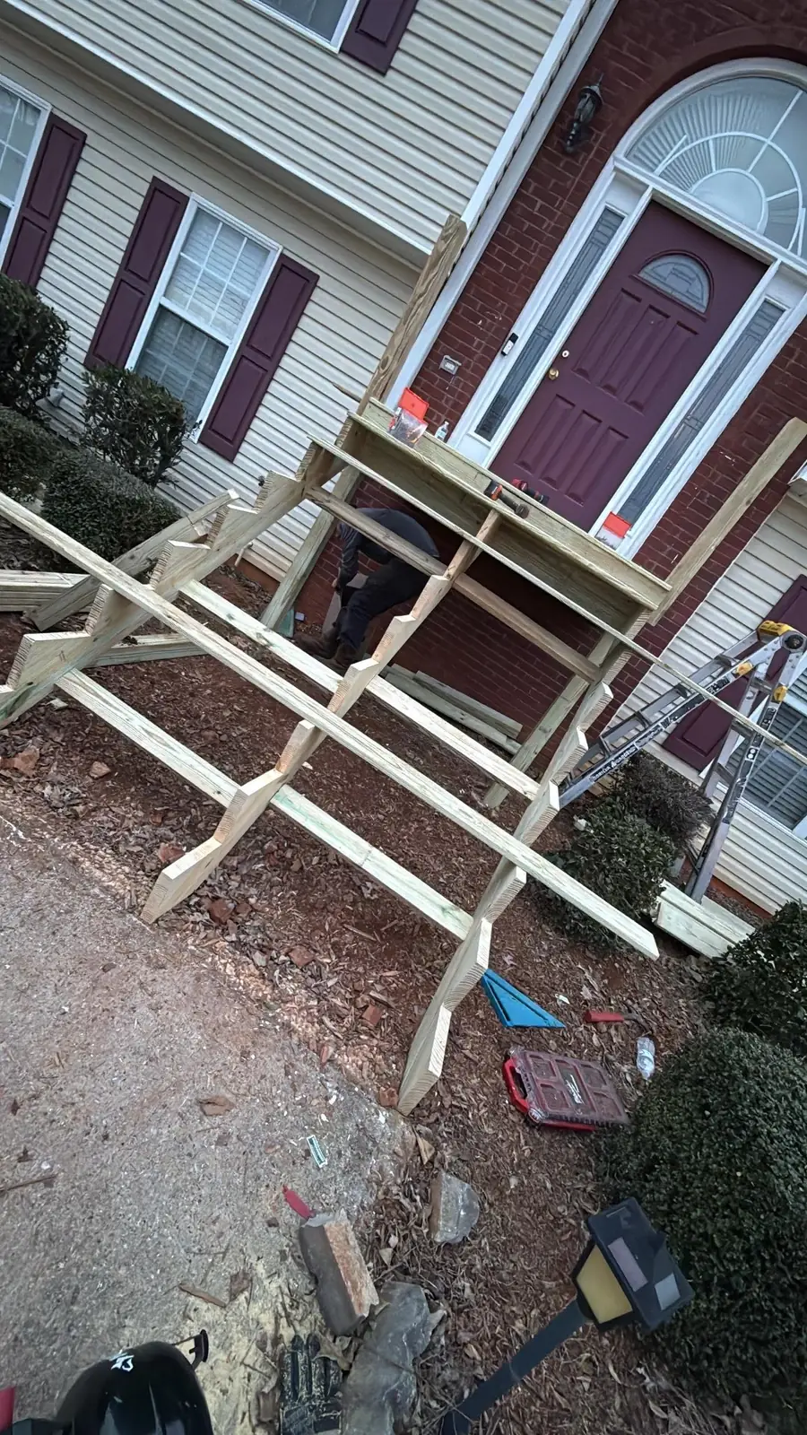The new framing up with the old stair gone, stringers and landing joists in place