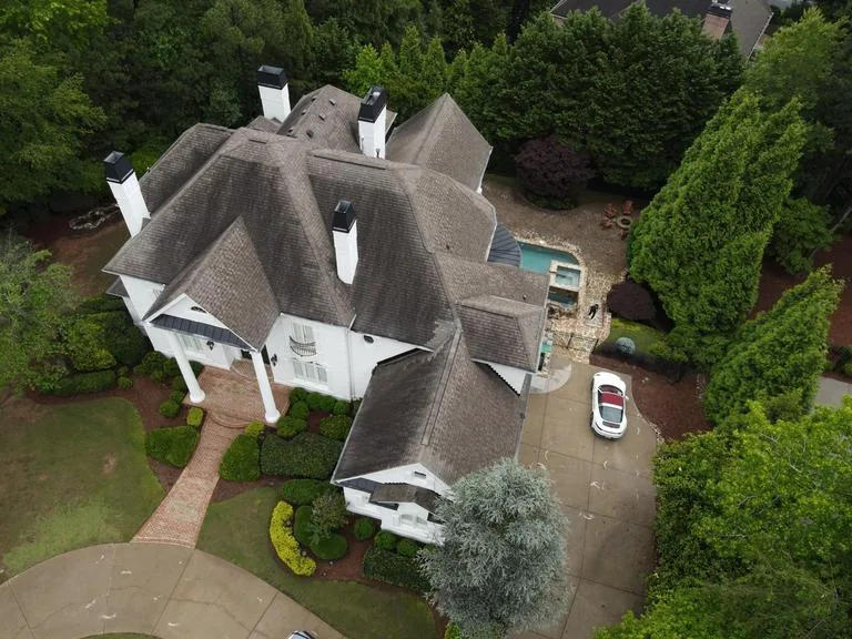 The front of the house from the air before the work started