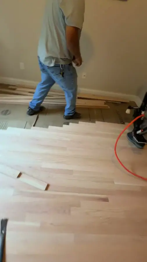 Two of the crew running new boards out across the room