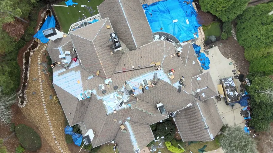 Drone pass over the tear off, decking exposed and tarps down over the finished sections